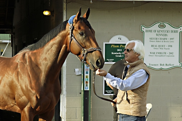 Hall of Fame trainer Bob Baffert walks Kentucky Derby winner American Pharoah out of the barn to show him off at Churchill Downs in Louisville, Ky., Sunday, May 3, 2015. American Pharoah is Baffert's fourth Kentucky Derby champion. (AP Photo/Garry Jones)
