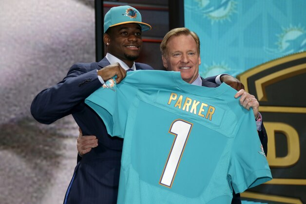 Devante Parker stands on stage with NFL commissioner Roger Goodell, right, after being drafted 14th by the Miami Dolphins in the first round of the 2015 NFL Draft, Thursday, April 30, 2015, in Chicago.  (Jeff Haynes/AP Images for Panini)