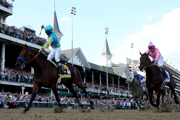 LOUISVILLE, KY - MAY 02:  Jockey Victor Espinoza celebrates as he guides American Pharoah #18 ahead of Firing Line #10, ridden by Gary Stevens, after crossing the finish line to win the 141st running of the Kentucky Derby at Churchill Downs on May 2, 2015 in Louisville, Kentucky.  (Photo by Rob Carr/Getty Images)