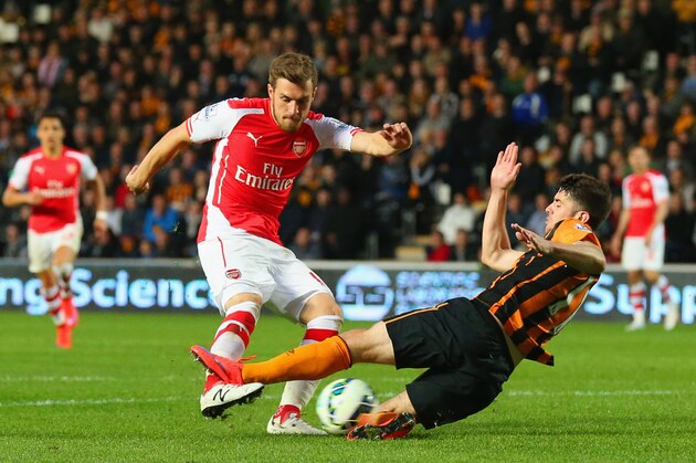 HULL, ENGLAND - MAY 04:  Aaron Ramsey of Arsenal (L) scores their second goal as Robbie Brady of Hull City attempts to block during the Barclays Premier League match between Hull City and Arsenal at KC Stadium on May 4, 2015 in Hull, England.  (Photo by Alex Livesey/Getty Images)