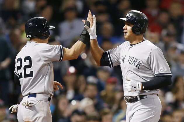 New York Yankees' Alex Rodriguez, right, celebrates after scoring with Jacoby Ellsbury (22) on a two-run double by Brian McCann during the third inning of a baseball game against the Boston Red Sox in Boston, Sunday, May 3, 2015. (AP Photo/Michael Dwyer)