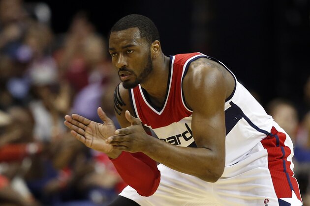 Washington Wizards guards John Wall (2) applauds as he stands ready in the second half of Game 4 in the first round of the NBA basketball playoffs against the Toronto Raptors, Sunday, April 26, 2015, in Washington. The Wizards won 125-94 to complete the first sweep of a seven-game series in club history, and advancing them to the second-round. (AP Photo/Alex Brandon)