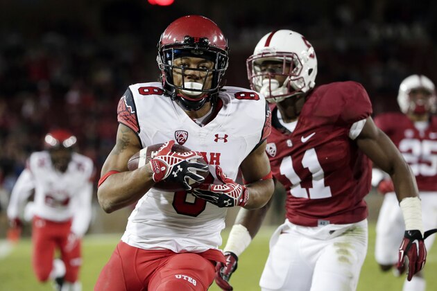 Utah wide receiver Kaelin Clay, center,  runs into the end zone with a touchdown catch next to Stanford cornerback Terrence Alexander (11) during overtime of an NCAA college football game on Saturday, Nov. 15, 2014, in Stanford, Calif. Utah won 20-17. (AP Photo/Marcio Jose Sanchez)