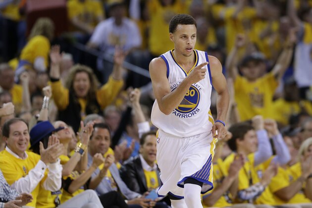 Golden State Warriors guard Stephen Curry (30) reacts after scoring against the Memphis Grizzlies during the first half of Game 1 in a second-round NBA playoff basketball series in Oakland, Calif., Sunday, May 3, 2015. (AP Photo/Marcio Jose Sanchez)