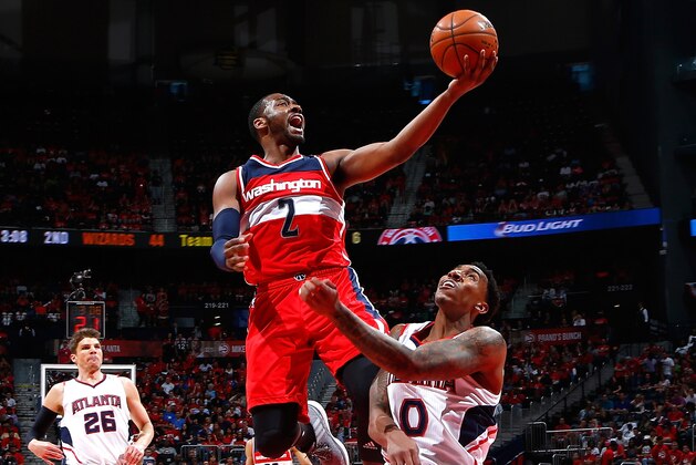 ATLANTA, GA - MAY 03:  John Wall #2 of the Washington Wizards attempts a layup over Jeff Teague #0 of the Atlanta Hawks during Game One of the Eastern Conference Semifinals of the 2015 NBA Playoffs at Philips Arena on May 3, 2015 in Atlanta, Georgia.  NOTE TO USER: User expressly acknowledges and agrees that, by downloading and/or using this photograph, user is consenting to the terms and conditions of the Getty Images License Agreement.  (Photo by Kevin C. Cox/Getty Images)