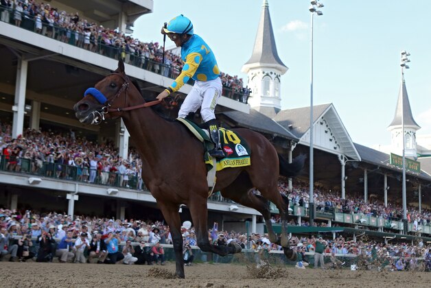 LOUISVILLE, KY - MAY 02:  Jockey Victor Espinoza celebrates as he guides American Pharoah #18 after crossing the finish line to win the 141st running of the Kentucky Derby at Churchill Downs on May 2, 2015 in Louisville, Kentucky.  (Photo by Rob Carr/Getty Images)