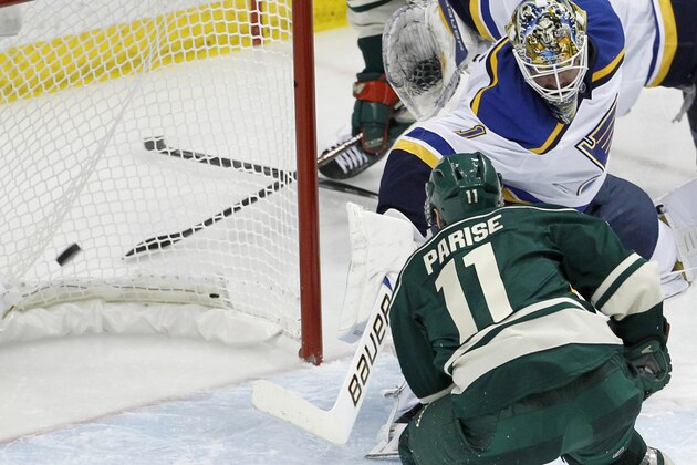 Minnesota Wild left wing Zach Parise (11) scores on St. Louis Blues goalie Brian Elliott (1) during the third period of Game 6 of an NHL hockey first-round playoff series in St. Paul, Minn., Sunday, April 26, 2015. The Wild won 4-1 to win the series and advance to the second round. (AP Photo/Ann Heisenfelt)