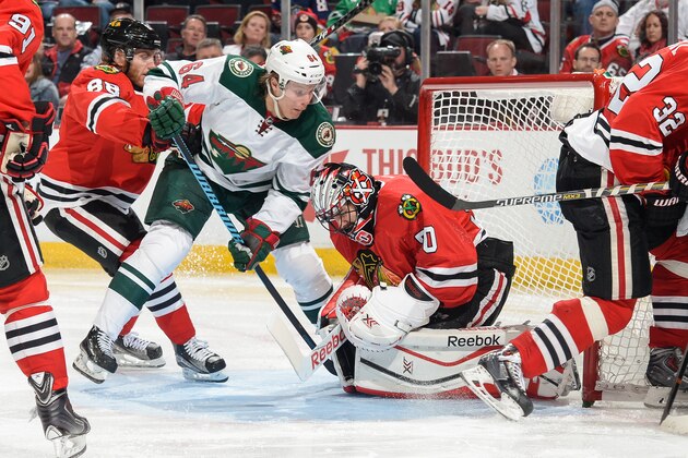 CHICAGO, IL - MAY 03:  Mikael Granlund #64 of the Minnesota Wild works to get the puck away from goalie Corey Crawford #50 of the Chicago Blackhawks, as Patrick Kane #88 pushes from the left, in Game Two of the Western Conference Semifinals during the 2015 NHL Stanley Cup Playoffs at the United Center on May 3, 2015 in Chicago, Illinois.  (Photo by Bill Smith/NHLI via Getty Images)