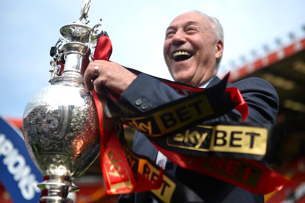 LONDON, ENGLAND - MAY 02:  Jeff Mostyn chairman of AFC Bournemouth lifts the Championship trophy after winning the the Sky Bet Championship after the game between Charlton Athletic and AFC Bournemouth at The Valley on May 2, 2015 in London, England.  (Photo by Justin Setterfield/Getty Images)