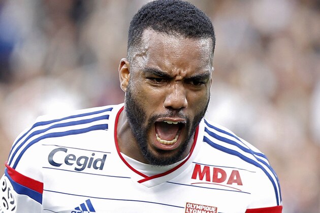 Lyon's Alexandre Lacazette celebrates after he scored his first goal against Lille during their French League One soccer match in Lyon, central France, Sunday, Oct. 5, 2014. (AP Photo/Laurent Cipriani)