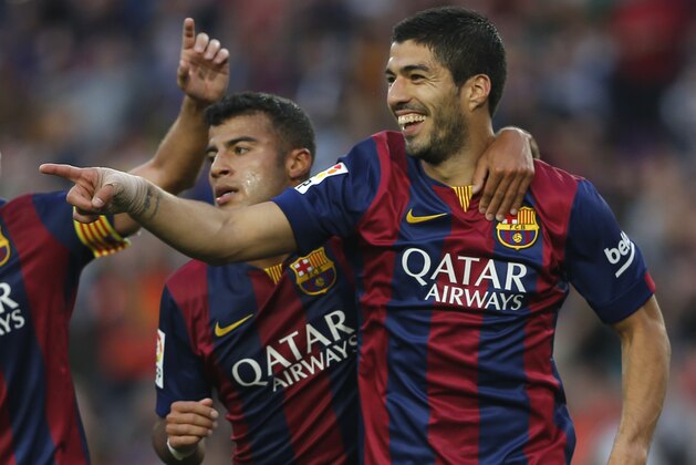 Barcelona's Luis Suarez, from Uruguay,-celebrates with teammates scoring his side's 2nd goal during a Spanish La Liga soccer match between F.C. Barcelona and Getafe at the Camp Nou stadium in Barcelona, Spain, Tuesday, April 28, 2015. (AP Photo/Emilio Morenatti)