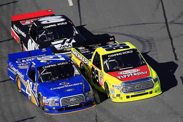 MARTINSVILLE, VA - MARCH 28:  Joey Logano, driver of the #29 Cooper Standard Ford, and Matt Crafton, driver of the #88 Hormel/Menards Toyota, race in front of Cole Custer, driver of the #00 Haas Automation Chevrolet, during the NASCAR Camping World Truck Series Kroger 250 at Martinsville Speedway on March 28, 2015 in Martinsville, Virginia.  (Photo by Rob Carr/Getty Images)