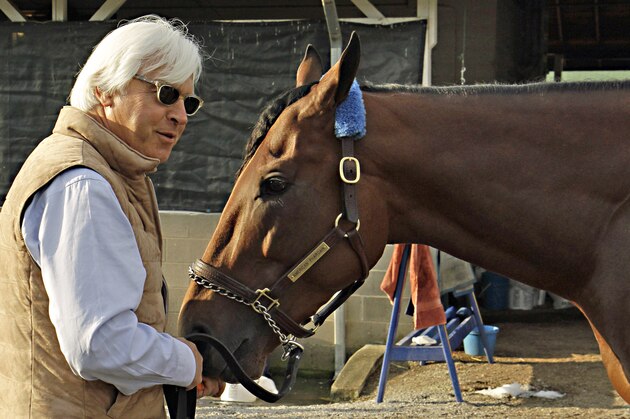 FILE - In this Sunday, May 3, 2015, file photo, Hall of Fame trainer Bob Baffert, left, feeds Kentucky Derby winner American Pharoah a carrot at Churchill Downs in Louisville, Ky., Sunday, May 3, 2015. Like almost every Kentucky Derby winner before him, American Pharoah is facing the inevitable question of whether he can win the Triple Crown. It hasn't been done since 1978, and with him and third-place Dortmund both trained by Baffert, it'll be interesting to see what happens at the Preakness. (AP Photo/Garry Jones, File)