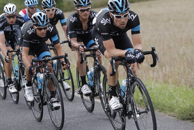Team Sky with Australia's Richie Porte, second left, ride during the seventh stage of the Tour de France cycling race over 234.5 kilometers (145.7 miles) with start in Epernay and finish in Nancy, France, Friday, July 11, 2014. Far left is team Omega Pharma-Quick Step's Tony Martin of Germany. (AP Photo/Christophe Ena)