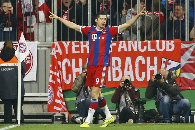 Bayern's Robert Lewandowski celebrates his side's opening goal during the German soccer cup (DFB Pokal) semifinal match between FC Bayern Munich and Borussia Dortmund at the Allianz Arena in Munich, Germany, on Tuesday, April 28, 2015. (AP Photo/Matthias Schrader)