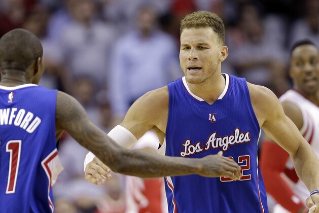 Los Angeles Clippers' Blake Griffin (32) celebrates with teammate Jamal Crawford (11) during the second half of Game 1 in a second-round NBA basketball playoff series against the Houston Rockets, Monday, May 4, 2015, in Houston. (AP Photo/David J. Phillip)