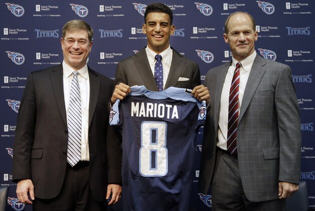 Marcus Mariota, center, former Oregon quarterback and overall No. 2 NFL football draft pick by the Tennessee Titans, poses with head coach Ken Whisenhunt, right, and general manager Ruston Webster, left, during a news conference Friday, May 1, 2015, in Nashville, Tenn. Mariota was selected by the Titans in the first round Thursday. (AP Photo/Mark Humphrey)