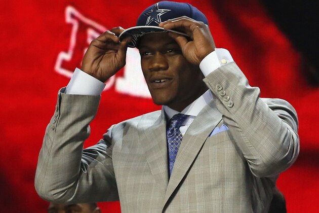 Nebraska defensive lineman Randy Gregory celebrates after being selected by the Dallas Cowboys as the 60th pick in the second round of the 2015 NFL Football Draft,  Friday, May 1, 2015, in Chicago. (AP Photo/Charles Rex Arbogast)