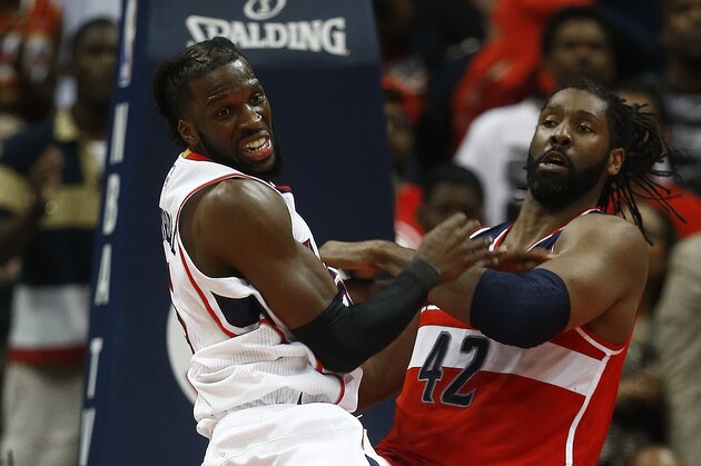 Atlanta Hawks forward DeMarre Carroll (5) and Washington Wizards forward Nene Hilario (42) watch a loose ball in the second half of game two of the second-round NBA playoff series basketball game  Tuesday, May 5, 2015, in Atlanta. Atlanta won 106-90. (AP Photo/John Bazemore)