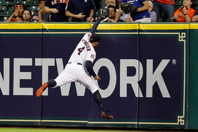 Houston Astros right fielder George Springer (4) makes a running catch on a fly ball hit Texas Rangers'  Adrian Beltre in the seventh inning in a baseball game Tuesday May 5, 2015, in Houston. (AP Photo/Bob Levey)