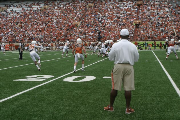 Texas head coach Charlie Strong, foreground, watches his team from the field during the first quarter of Texas' Orange and White spring NCAA college football game, Saturday, April 18, 2015, in Austin, Texas. (AP Photo/Michael Thomas)