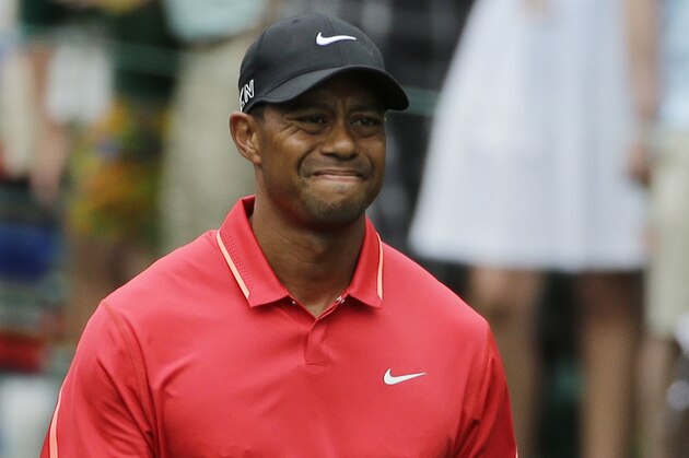 Tiger Woods grimaces after teeing off on the seventh hole during the fourth round of the Masters golf tournament Sunday, April 12, 2015, in Augusta, Ga. (AP Photo/Matt Slocum)