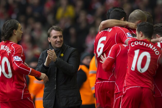 Liverpool's manager Brendan Rodgers, centre left, applauds as his players celebrate a goal by Jordan Henderson during the English Premier League soccer match between Liverpool and Manchester City at Anfield Stadium, Liverpool, England, Sunday, March 1, 2015. (AP Photo/Jon Super)