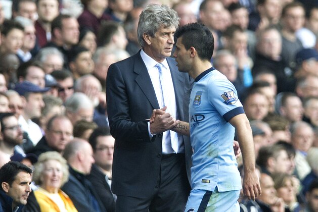 Manchester City's Sergio Aguero shakes hands with his manager Manuel Pellegrini after being substituted during the English Premier League soccer match between Tottenham Hotspurs and Manchester City, at White Hart Lane Stadium in London, Sunday, May 3, 2015. (AP Photo/Bogdan Maran)
