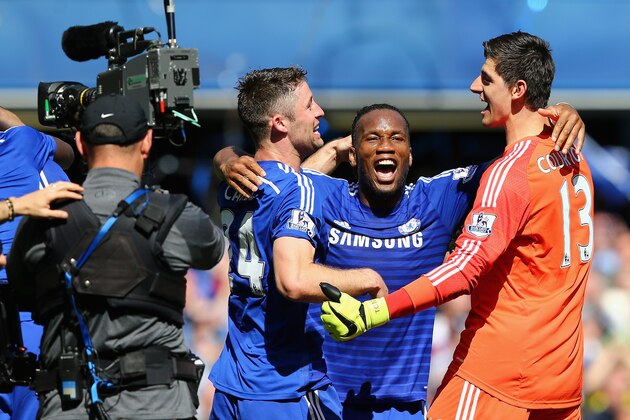 LONDON, ENGLAND - MAY 03:   Gary Cahill, Didier Drogba and Thibaut Courtois of Chelsea celebrate winning the Premier League title after the Barclays Premier League match between Chelsea and Crystal Palace at Stamford Bridge on May 3, 2015 in London, England.  (Photo by Clive Mason/Getty Images)