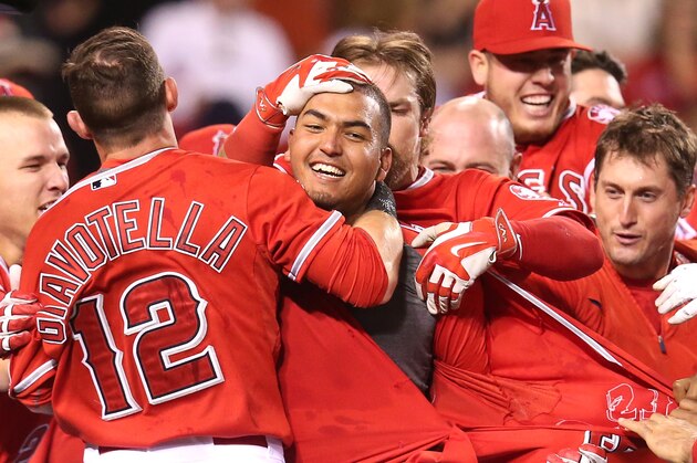 ANAHEIM, CA - MAY 05:  Carlos Perez #58 (C) of the Los Angeles Angels of Anaheim is mobbed by teammates after leading off the ninth inning with a walk off home run to win the game against the Seattle Mariners at Angel Stadium of Anaheim on May 5, 2015 in Anaheim, California.  The Angels won 5-4.  (Photo by Stephen Dunn/Getty Images)