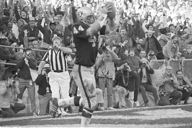 Raiders' running back Marv Hubbard (44) holds the ball aloft after blasting into the end zone for a touchdown against Kansas City Chiefs in the third quarter at Oakland, Calif., Dec. 12, 1970.  It was the Raiders' first touchdown of the game.  (AP Photo)