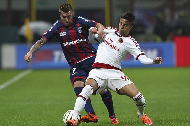 MILAN, ITALY - NOVEMBER 05:  Julio Alberto Buffarini of San Lorenzo competes for the ball with Hachim Mastour of AC Milan during Luigi Berlusconi Trophy at Stadio Giuseppe Meazza on November 5, 2014 in Milan, Italy.  (Photo by Marco Luzzani/Getty Images)
