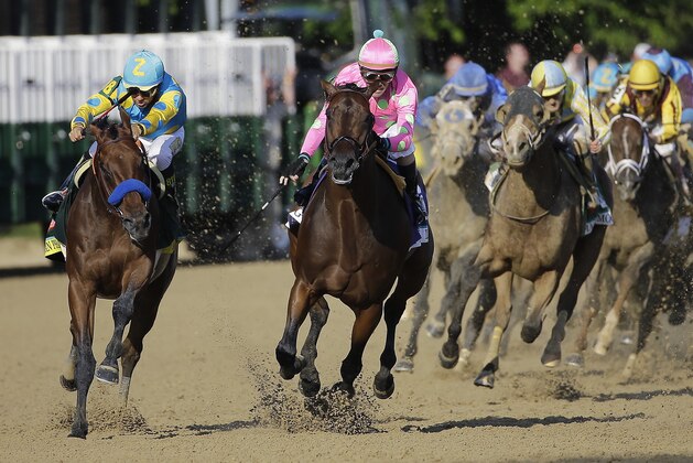Victor Espinoza, left, rides American Pharoah to victory in the 141st running of the Kentucky Derby horse race at Churchill Downs Saturday, May 2, 2015, in Louisville, Ky.  (AP Photo/Matt Slocum)