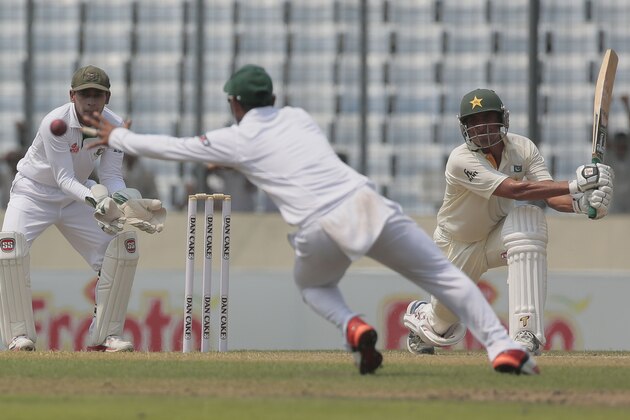Pakistan’s Younis Khan, right, plays a shot, as Bangladesh’s Shuvagata Hom, center, attempts to catch the ball and captain Mushfiqur Rahim watches during the first day of their second test cricket match in Dhaka, Bangladesh, Wednesday, May 6, 2015. (AP Photo/ A.M. Ahad)