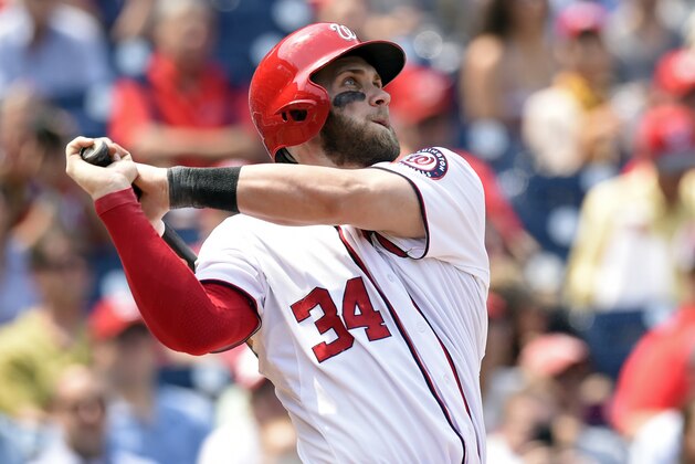Washington Nationals right fielder Bryce Harper (34) watches the ball after hitting a second home run against the Miami Marlins during the third inning of their baseball game at Nationals Park in Washington, Wednesday, May 6, 2015. (AP Photo/Susan Walsh)