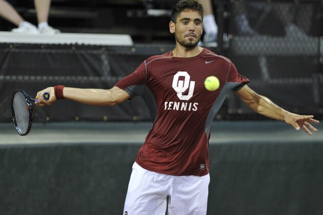 Oklahoma's Axel Alvarez returns a volley to Southern California's Ray Sarmiento during a men's team singles match in the NCAA Division I tennis championships, Tuesday, May 20, 2014, in Athens, Ga. Southern California defeated Oklahoma to take the title. (AP Photo/David Tulis)