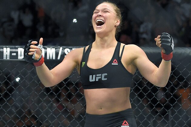 FILE - In this Feb. 28, 2015 file photo, Ronda Rousey, with Reebok insignia on her uniform, celebrates after defeating Cat Zingano in a UFC 184 mixed martial arts bantamweight title bout in Los Angeles. UFC fighters will be paid for wearing Reebok gear based on their tenure in the octagon under the mixed martial arts promotion’s new sponsorship deal. The UFC on Wednesday, May 6, 2015, announced the change in its pay structure for its deal with Reebok, which signed on late last year to outfit every fighter. (AP Photo/Mark J. Terrill, File)