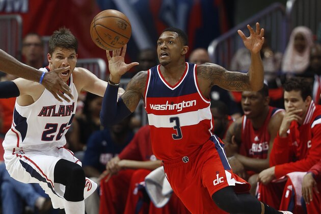 Washington Wizards guard Bradley Beal (3) chases a loose ball as Atlanta Hawks guard Kyle Korver (26) looks on in the first half of game two of the second-round NBA playoff series basketball game, Tuesday, May 5, 2015, in Atlanta. (AP Photo/John Bazemore)