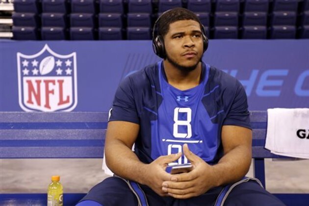 FILE - In this Feb. 20, 2015, file photo, La'el Collins sits on a bench at the NFL football scouting combine in Indianapolis. Collins is an undrafted free agent because NFL teams decided against selecting the former All-Southeastern Conference offensive tackle from LSU in last week’s draft. Collins was widely projected as a first-round choice. While he has not been named as a suspect or even a person of interest in any crime, teams became apprehensive about drafting him when Baton Rouge Police said they wanted to interview Collins about the shooting death of a pregnant woman he knew. (AP Photo/Julio Cortez, File)