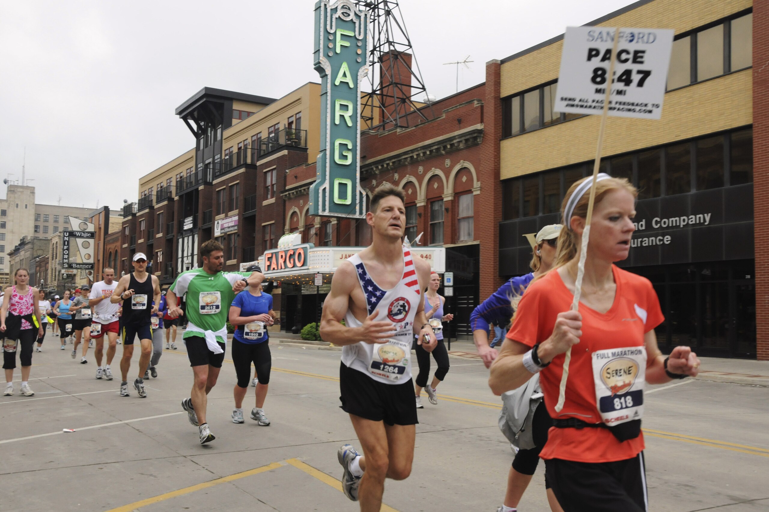 FILE - In this May 21, 2011 file photo provided by the Department of Defense, Maj. George Kraehe, of Albequerque, N.M., center,  and other runners pass the Fargo Theater during a marathon in Fargo, N.D. The Fargo Marathon, being run Saturday, May, 10, 2014, is celebrating its 10th anniversary this year with more than 23,000 participants. (AP Photo/Department of Defense, Senior Master Sgt. David H. Lipp, File)