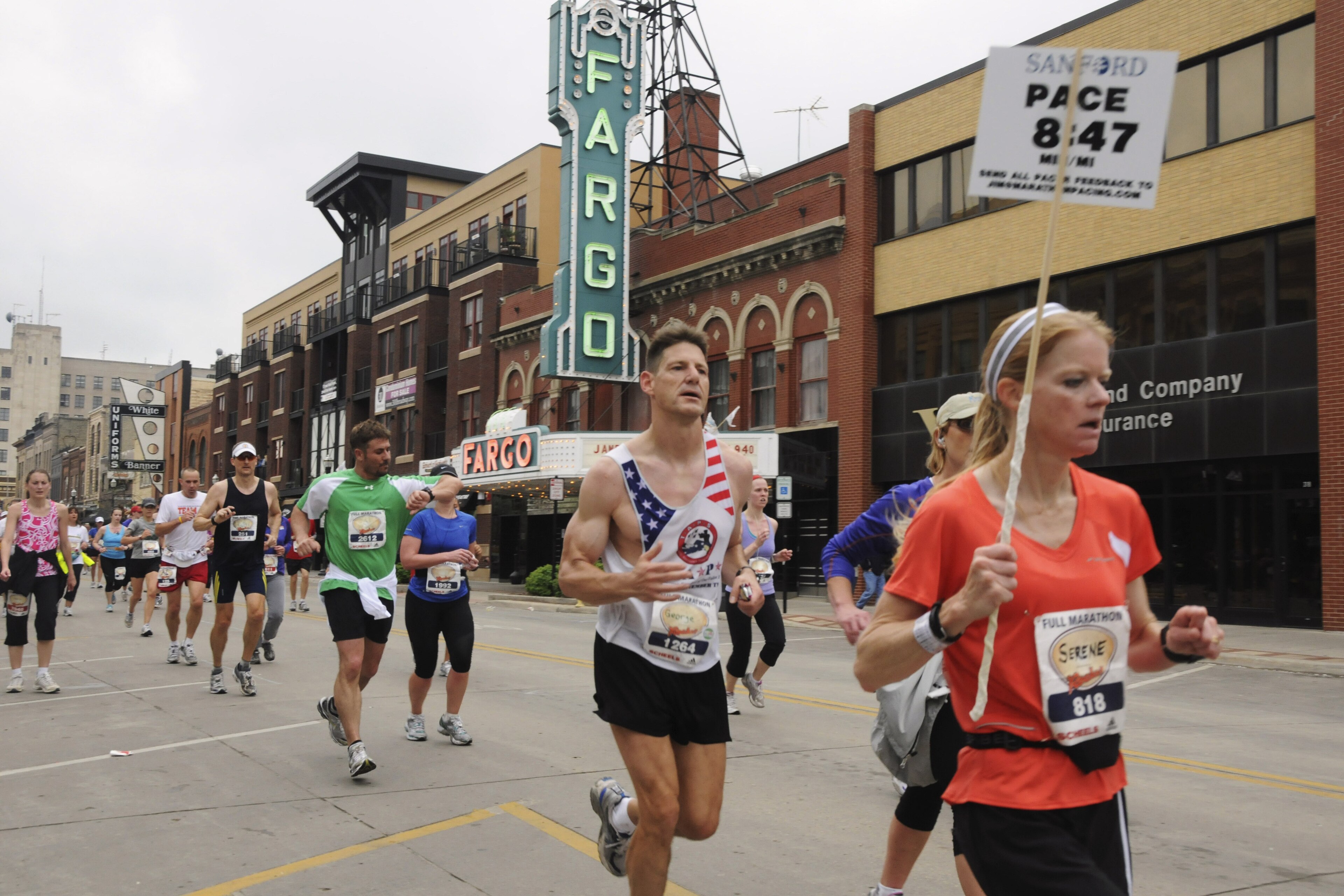 FILE - In this May 21, 2011 file photo provided by the Department of Defense, Maj. George Kraehe, of Albequerque, N.M., center,  and other runners pass the Fargo Theater during a marathon in Fargo, N.D. The Fargo Marathon, being run Saturday, May, 10, 2014, is celebrating its 10th anniversary this year with more than 23,000 participants. (AP Photo/Department of Defense, Senior Master Sgt. David H. Lipp, File)