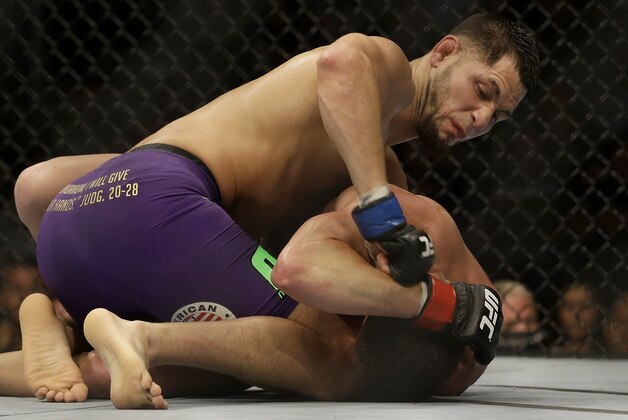 Jorge Masvidal, top, punches Daron Cruickshank during a lightweight mixed martial arts bout at a UFC on Fox event in San Jose, Calif., Saturday, July 26, 2014. Masvidal won by unanimous decision. (AP Photo/Jeff Chiu)