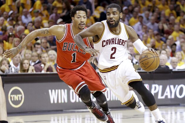 Cleveland Cavaliers guard Kyrie Irving (2) drives to the lane against Chicago Bulls guard Derrick Rose (1) during the first half of Game 1 in a second-round NBA basketball playoff series Monday, May 4, 2015, in Cleveland. (AP Photo/Tony Dejak)