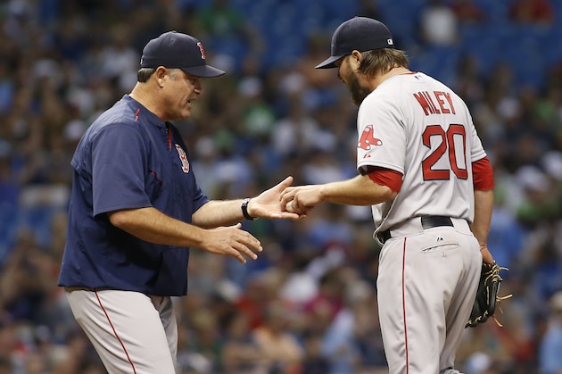 ST. PETERSBURG, FL - APRIL 21:  Manager John Farrell #53 of the Boston Red Sox takes pitcher Wade Miley #20 out of the game after Miley walked Evan Longoria of the Tampa Bay Rays to load the bases during the sixth inning of a game on April 21, 2015 at Tropicana Field in St. Petersburg, Florida.  (Photo by Brian Blanco/Getty Images)