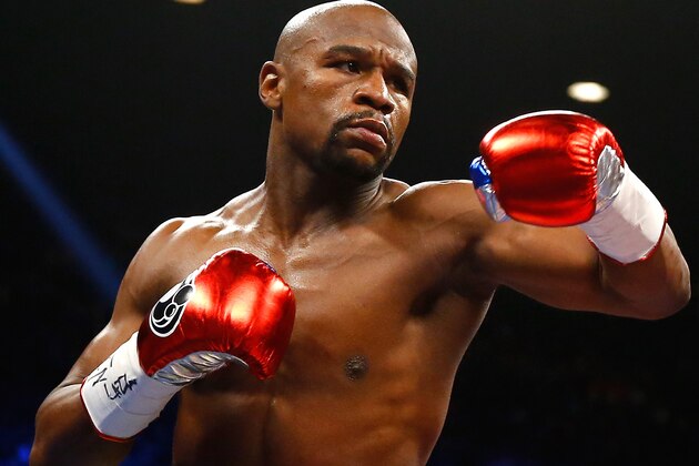 LAS VEGAS, NV - MAY 02:  Floyd Mayweather Jr. throws a left at Manny Pacquiao during their welterweight unification championship bout on May 2, 2015 at MGM Grand Garden Arena in Las Vegas, Nevada.  (Photo by Al Bello/Getty Images)