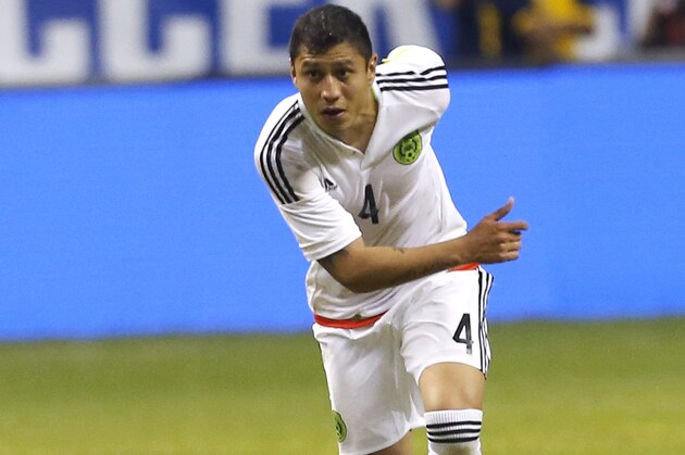 SAN ANTONIO, TX - APRIL 15:  Julio Cesar Dominguez #4 of Mexico advances the ball against the United States during an international friendly match at the Alamodome on April 15, 2015 in San Antonio, Texas.  (Photo by Chris Covatta/Getty Images)