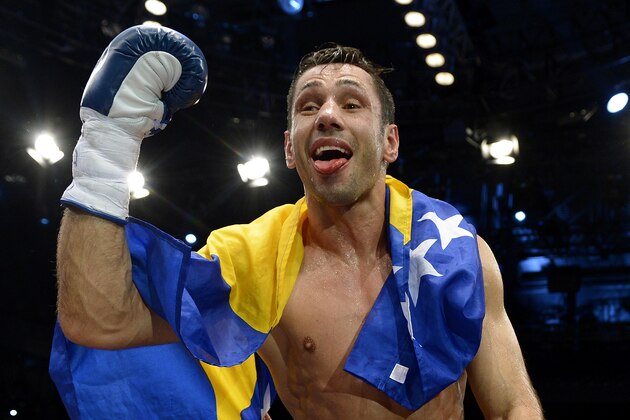 Challenger Felix Sturm from Germany celebrates his victory after his middleweight title bout against Darren Barker of Britain in Stuttgart, southern Germany, Saturday, Dec. 7, 2013. Sturm defeated defending champion  Barker with a second round TKO to take the Briton's IBF middleweight title on Saturday.  (AP Photo/Daniel Kopatsch)