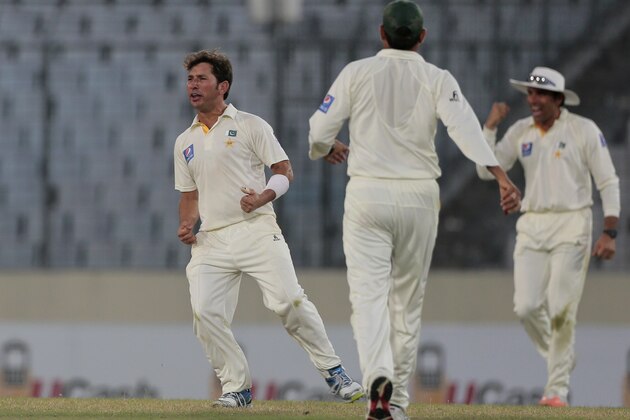 Pakistan’s Yasir Shah, left, and his teammates celebrate the dismissal of Bangladesh’s captain Mushfiqur Rahim during their second day of the second test cricket match in Dhaka, Bangladesh, Thursday, May 7, 2015. (AP Photo/ A.M. Ahad)