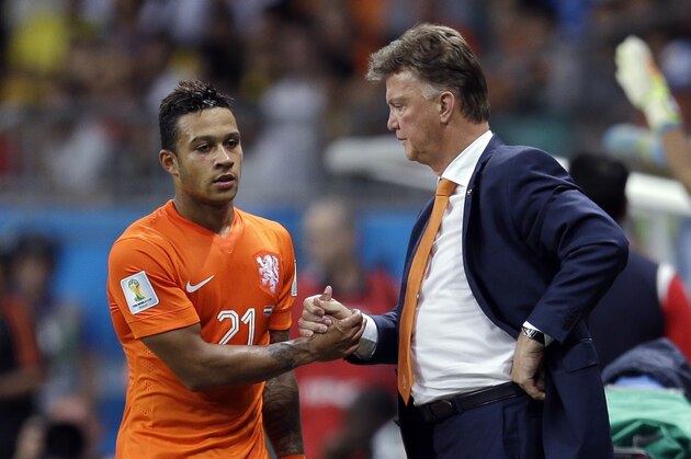 Netherlands' head coach Louis van Gaal shakes hands with Memphis Depay as he comes off during the World Cup quarterfinal soccer match between the Netherlands and Costa Rica at the Arena Fonte Nova in Salvador, Brazil, Saturday, July 5, 2014. (AP Photo/Natacha Pisarenko)