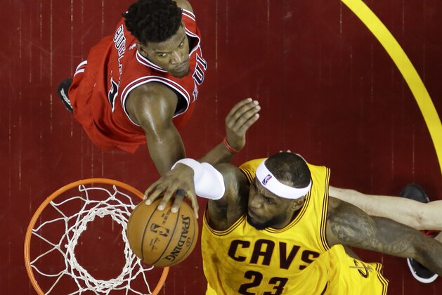 Cleveland Cavaliers forward LeBron James (23) dunks the ball against Chicago Bulls guard Jimmy Butler (21) during the first half of Game 2 in a second-round NBA basketball playoff series Wednesday, May 6, 2015, in Cleveland. (AP Photo/Tony Dejak)